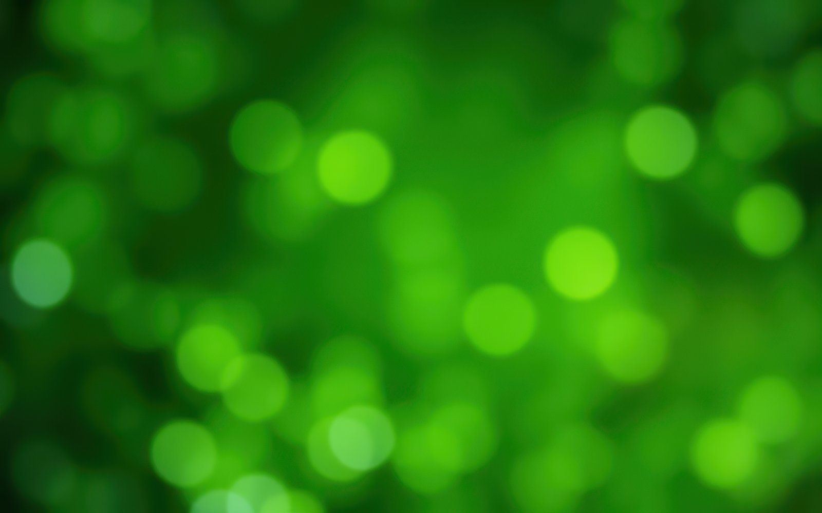 Vibrant green bokeh lights create a magical atmosphere in a lush natural setting